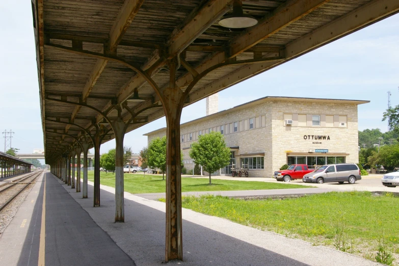 a very long covered walkway by a train