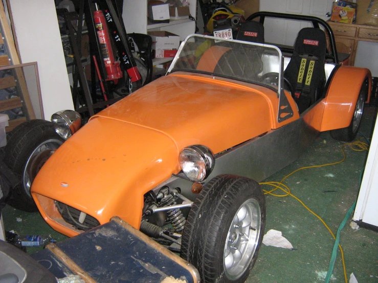 an orange vehicle is sitting in a garage