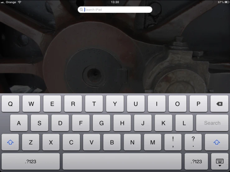 an apple keyboard with a machine wheel on the bottom of it