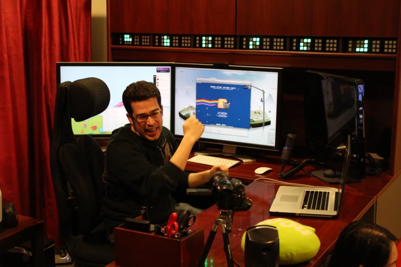 a man working on a computer with two monitors