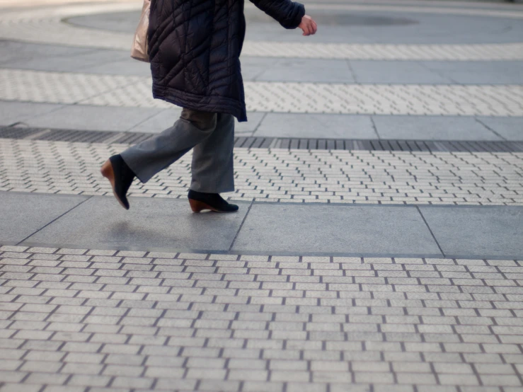 a woman is walking with her hand on the ground