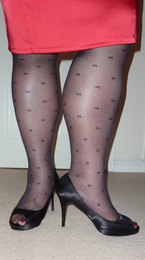 woman with high heels wearing a black patterned stockings