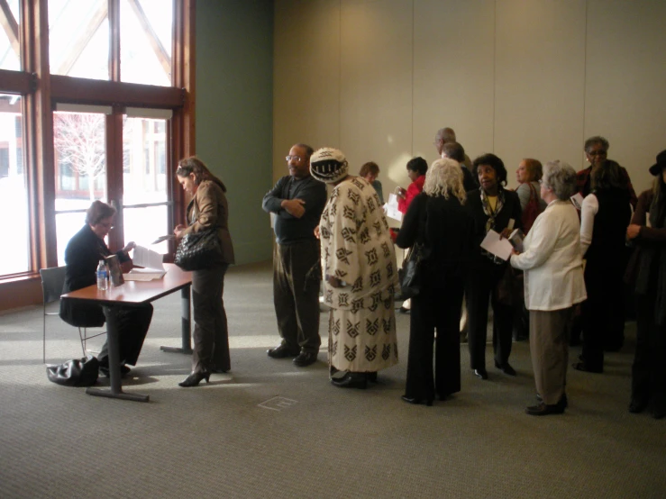 people stand in line to be interviewed at a public event