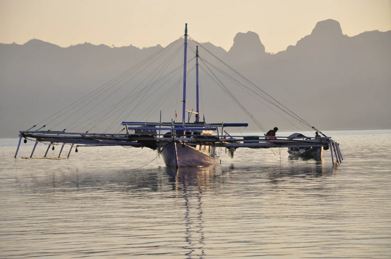 a couple of boats floating next to each other in the water