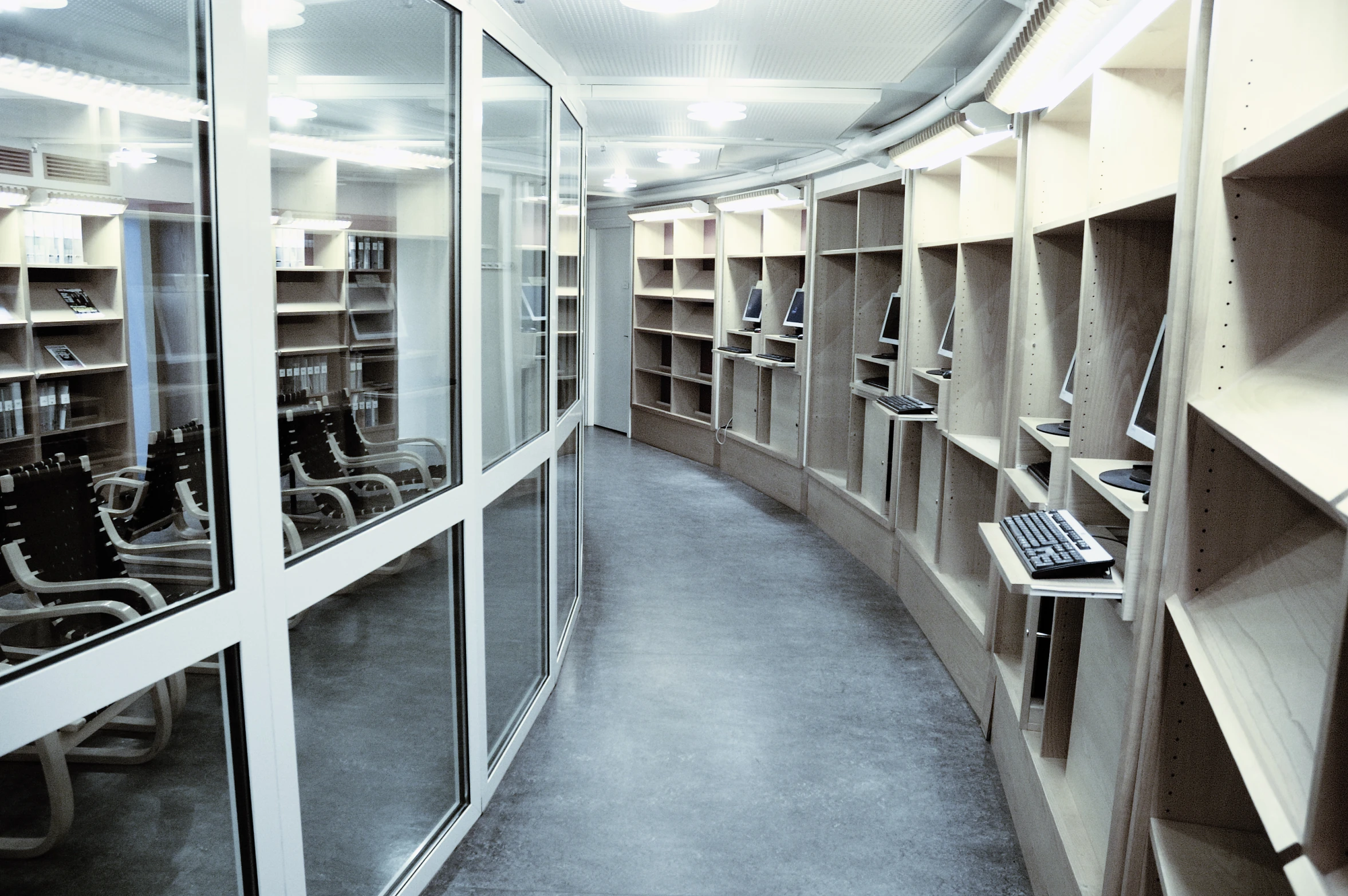 the view of some computers sitting inside of a room with shelves