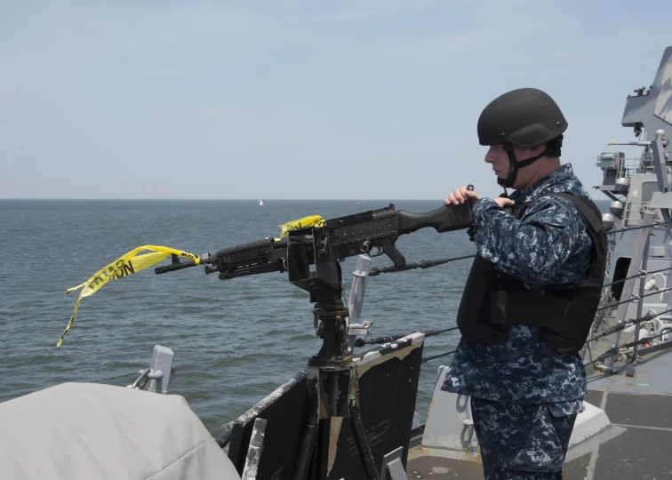 a man wearing a helmet and holding onto the side of a boat