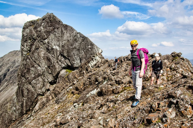 a group of people hiking up the side of a mountain