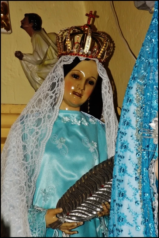 a statue of the virgin mary of lougar in blue