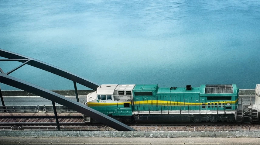 an ocean passenger train is rolling along the track