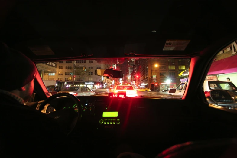 a car's interior light reflects off the car mirror