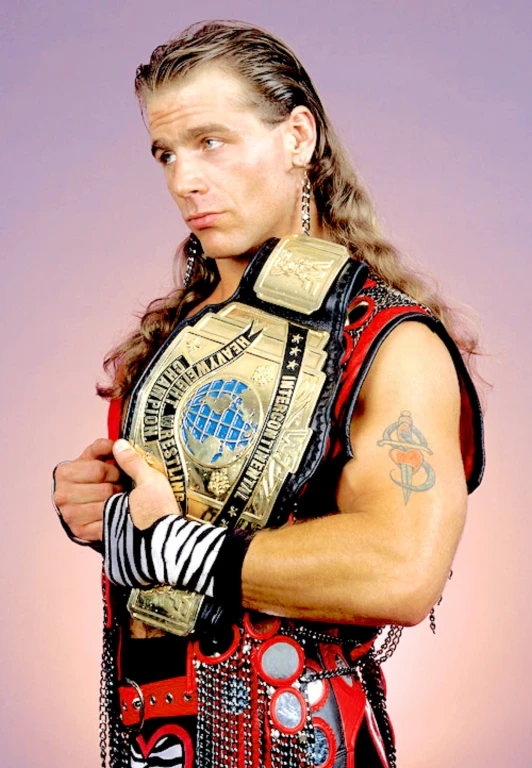 man with long hair holding his wwfc title belt