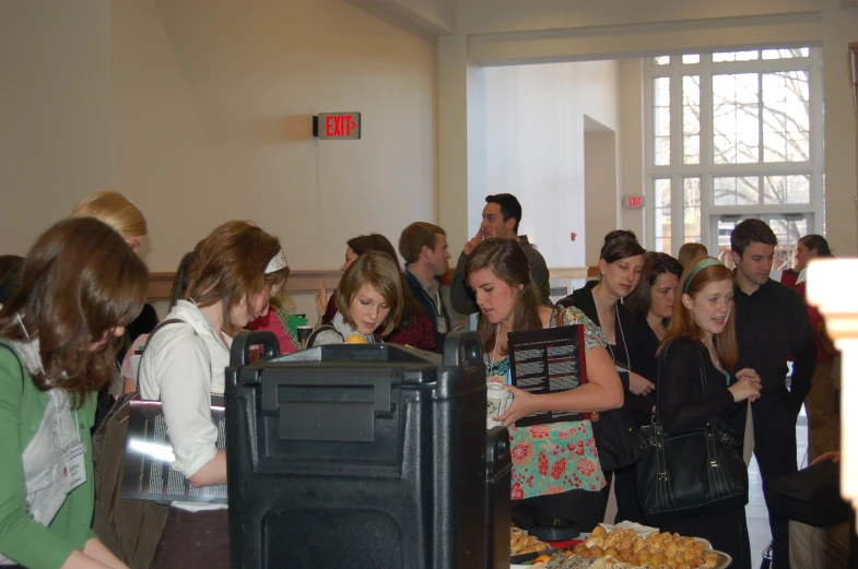 there is a large group of people gathered at a buffet