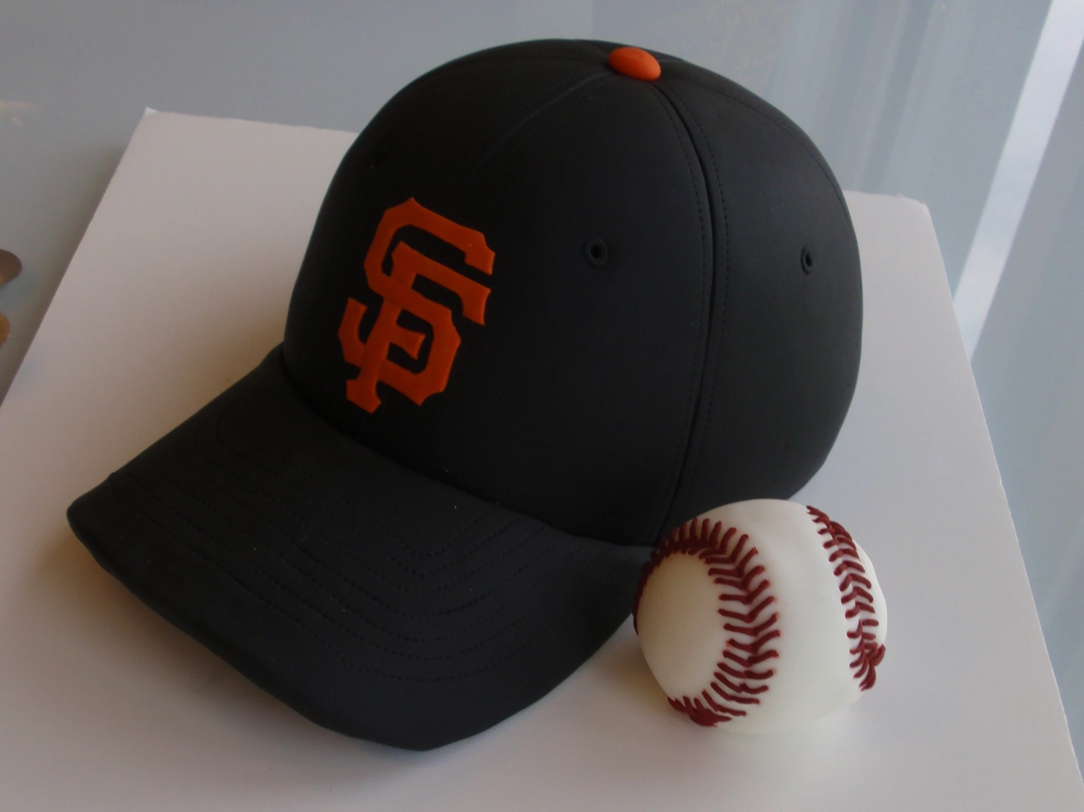 a black hat with a baseball sitting on top of it