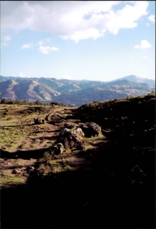 view of mountains from the edge of a grassy field