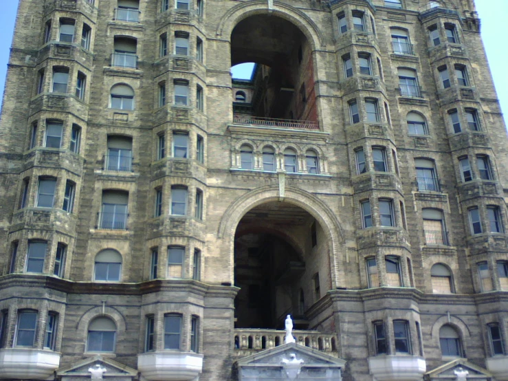 an old clock tower has many windows and ornate balconies