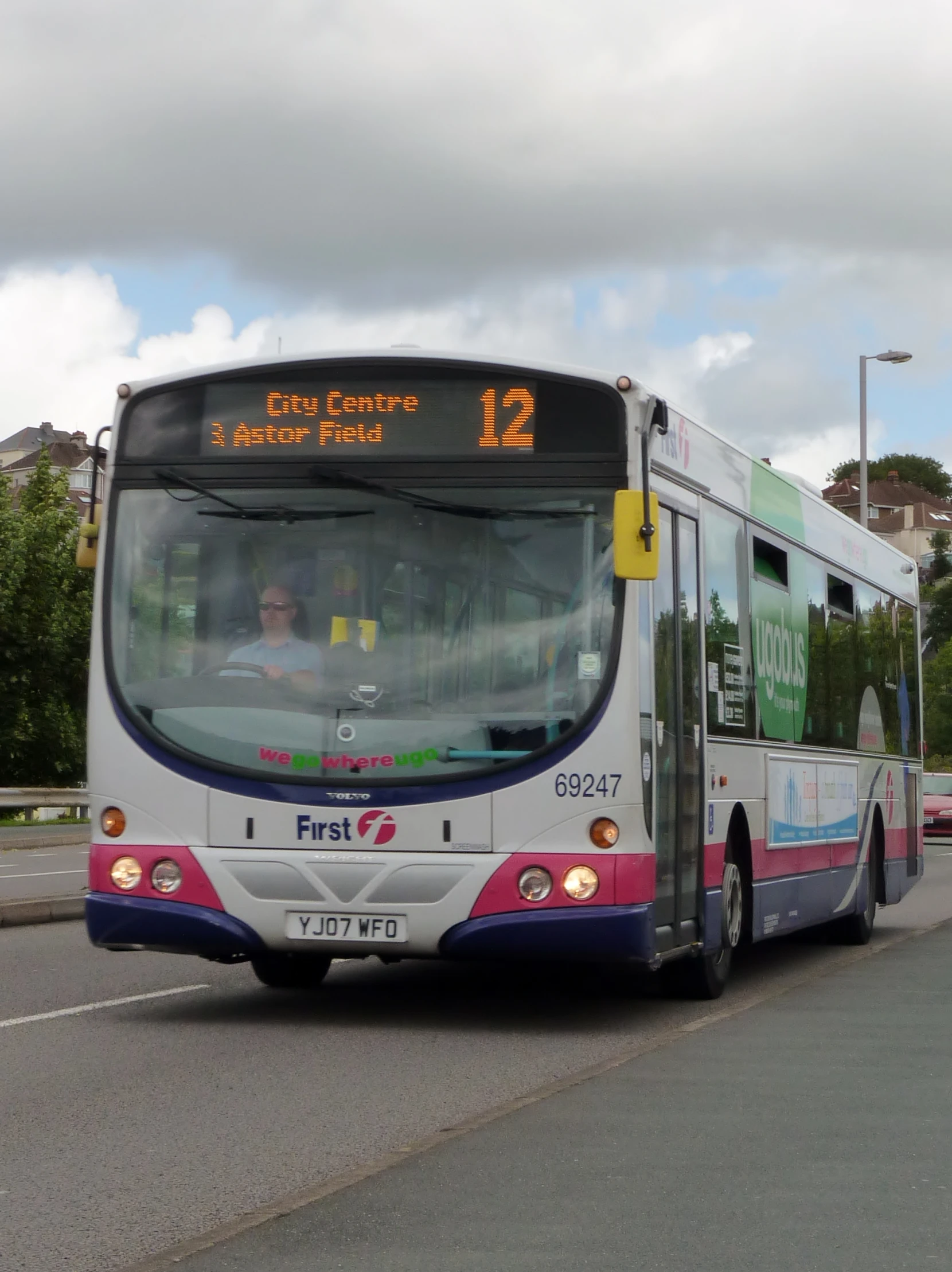 a bus is pulling away from a stop to pick up passengers