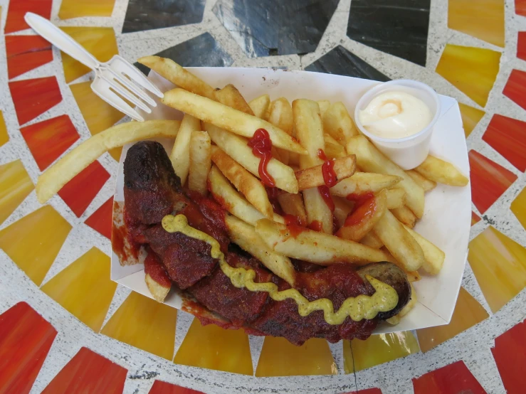 a sandwich, fries and ketchup are served on a plate