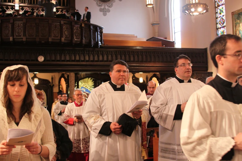 a group of people with white dresses and religious flags