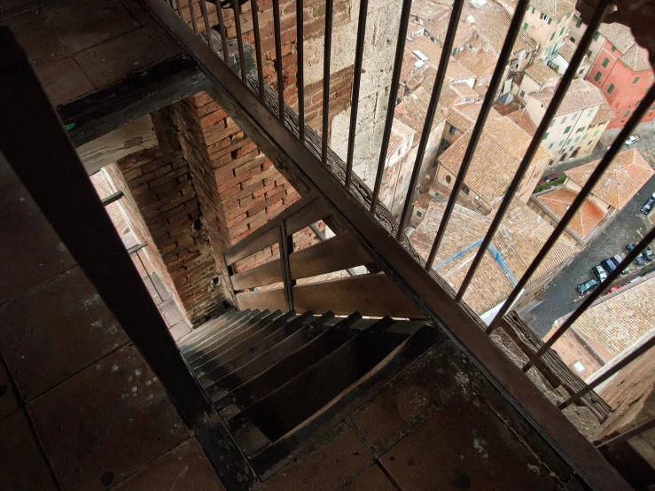 a stair case with a gate leading down to a city