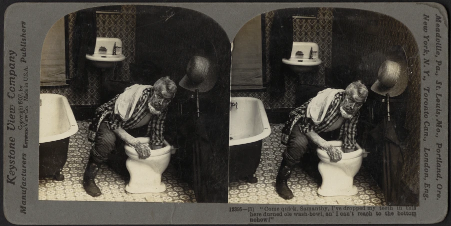 a man with some kind of hat sits on the toilet