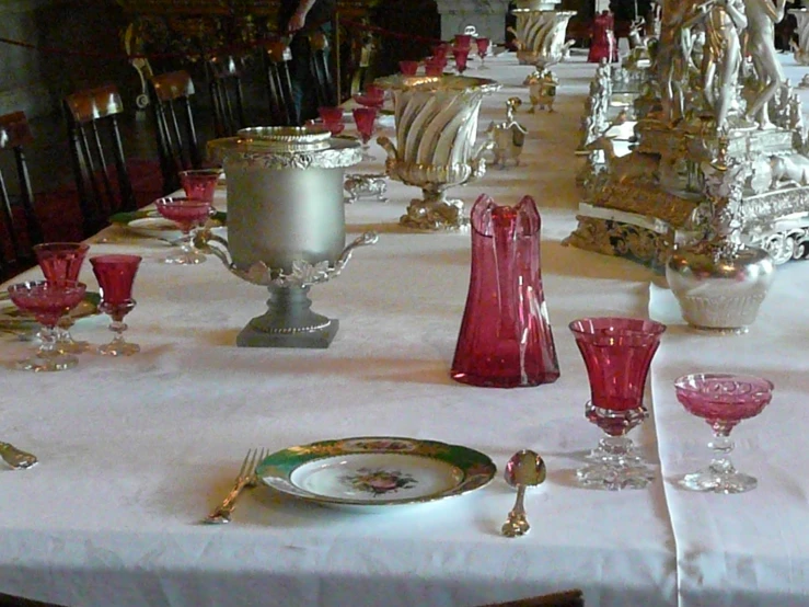 a table with many china dishes and wine glasses