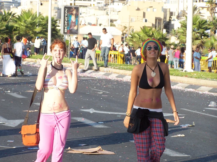 two young ladies walking down the street with confetti in their hair