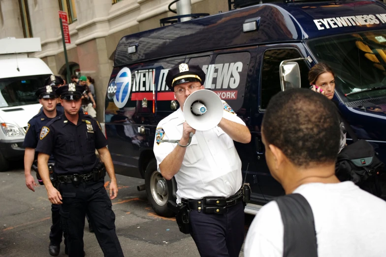 a police man with a white horn talking to a police officer