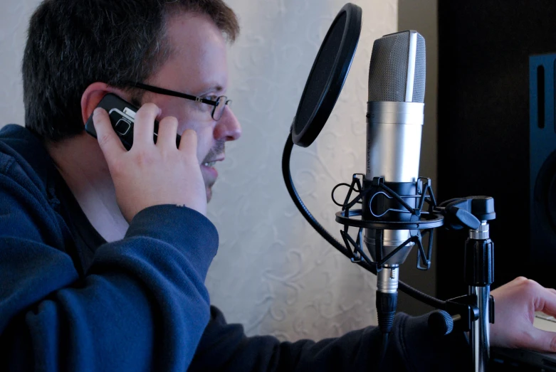 man talking on the phone near the microphone