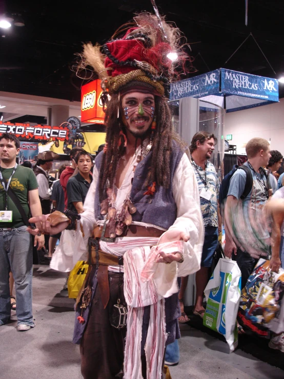 a man with long dreadlocks and a pirate costume at an event