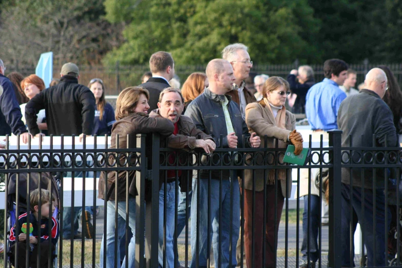 several people at an outdoor event looking on