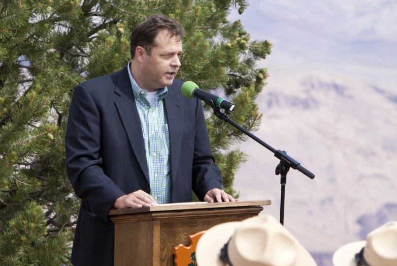 man at a podium speaking at a podium