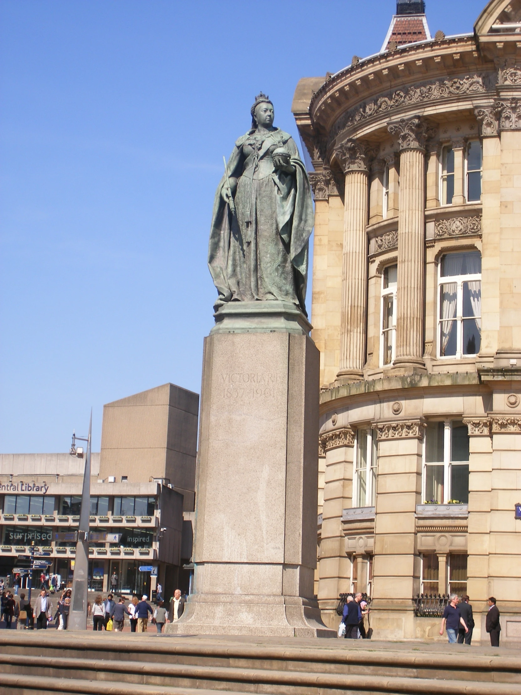 an older statue of a monk beside an old building