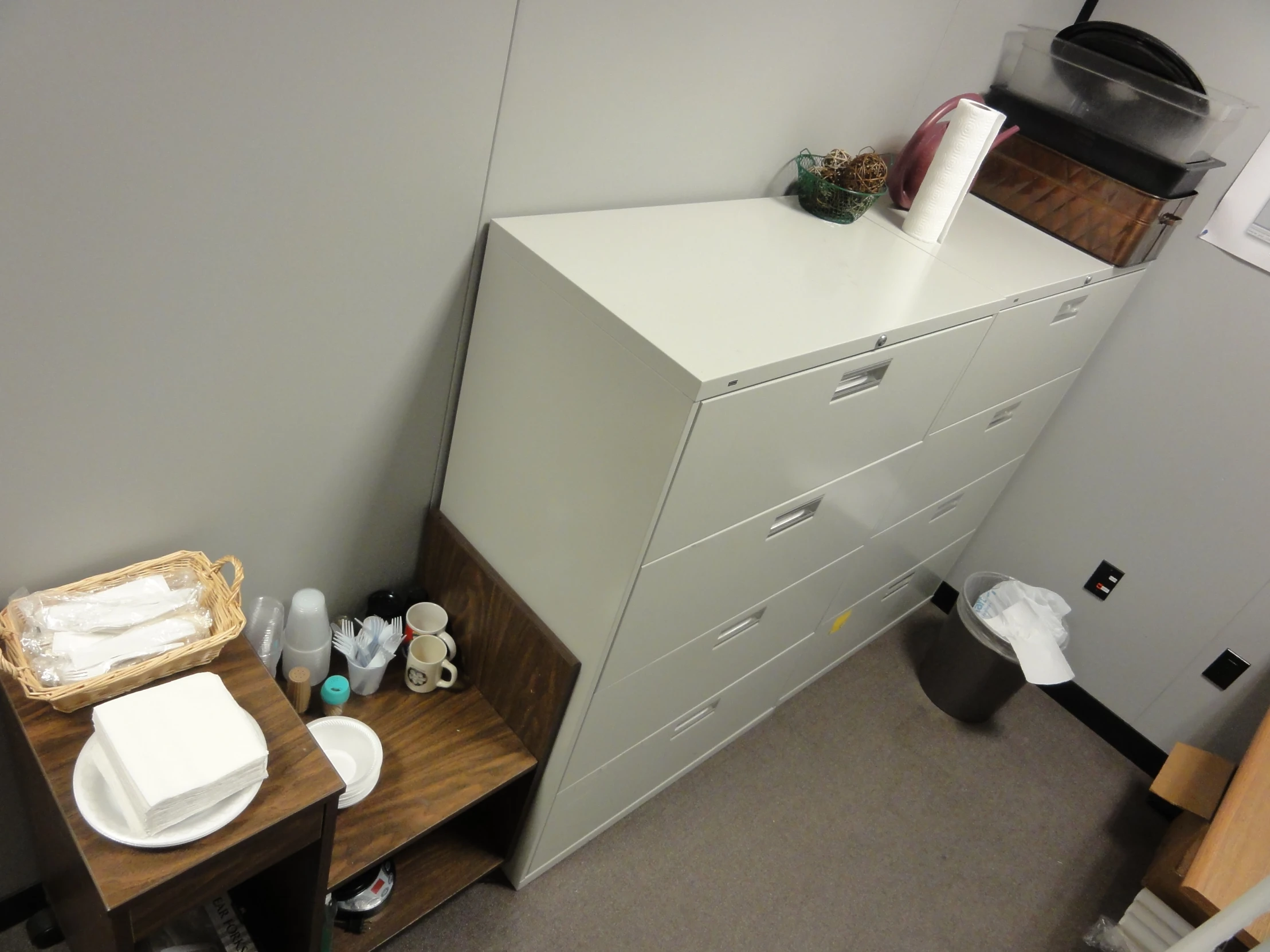 a room with several cabinets and a small table with dishes on top