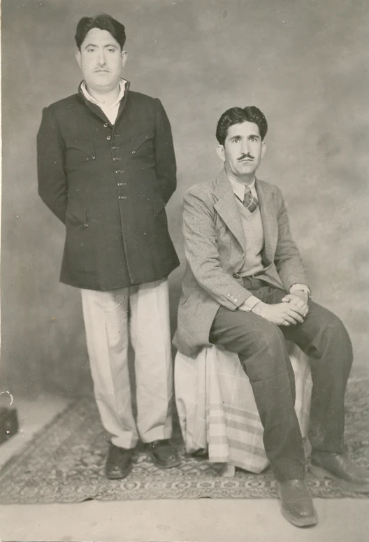 this is an old picture of two people in formal attire
