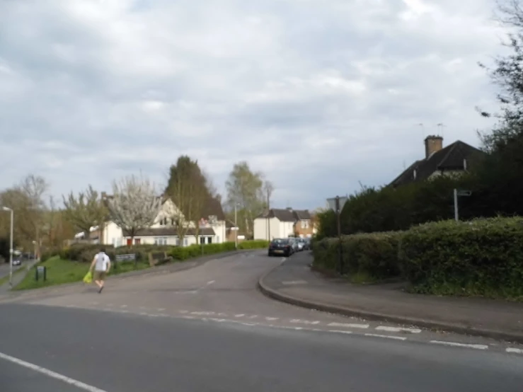 person walking on a quiet suburban street