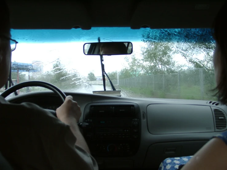 two people in a car inside an automobile