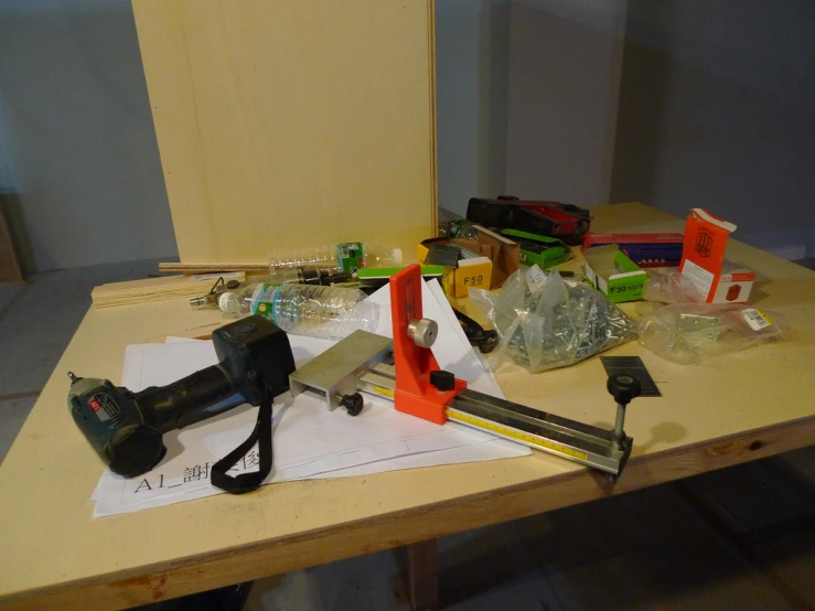 tools, rulers, tape, measuring tape and paper sitting on a wooden desk