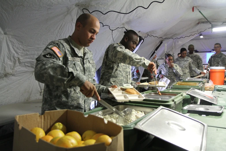 some soldiers serving out soing from a box