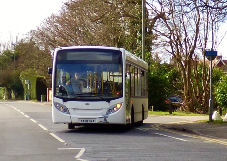 a bus traveling down the street near houses