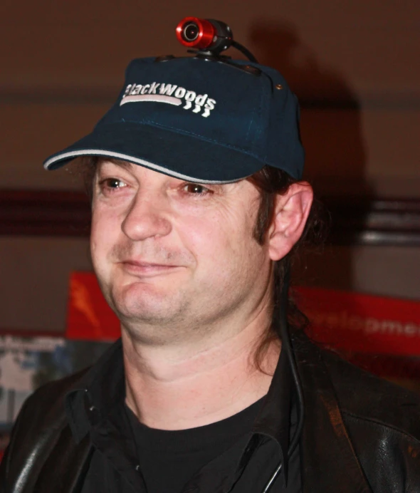 a person wearing a black jacket and hat