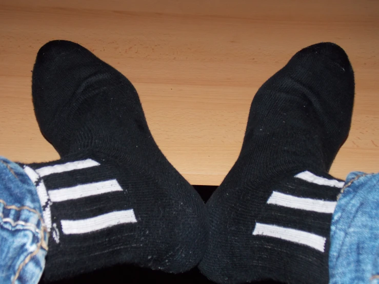 the pair of legs have been worn with adidas
