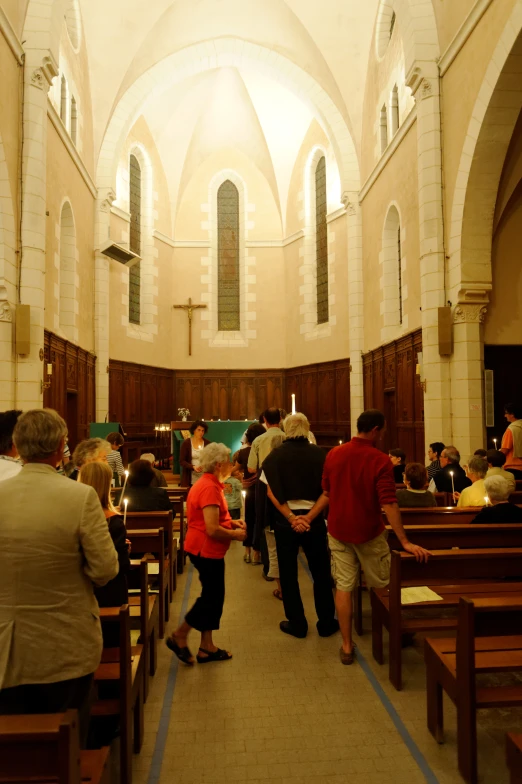 people praying at the alters of a church