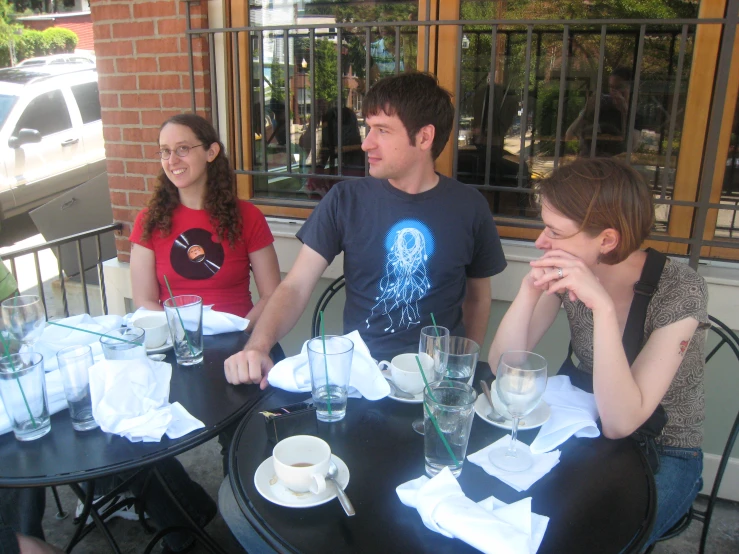 a couple of women and a man sitting at tables