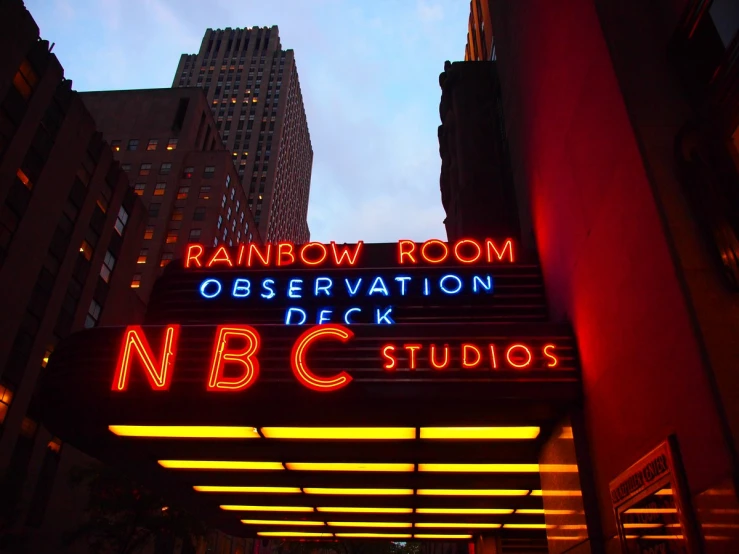 a colorful neon sign on top of a building