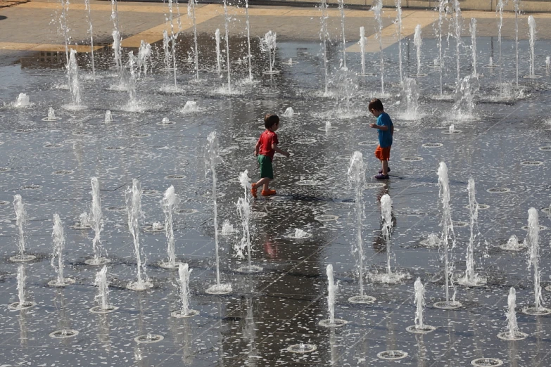 s playing in a fountain of water