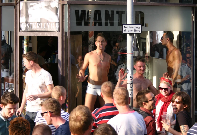 there are men standing around drinking some beer