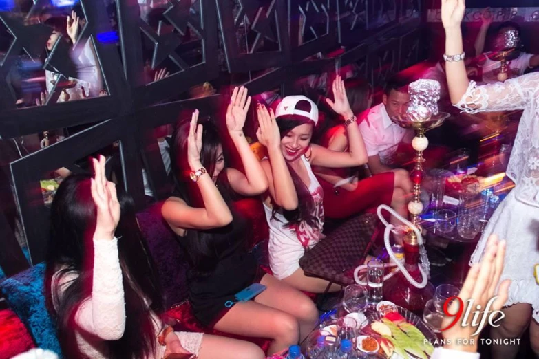 people celeting at a party with dancing hands up