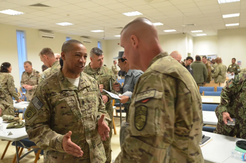 a group of men in military uniforms talking