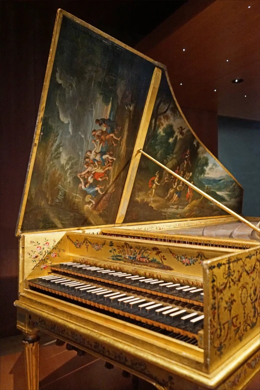 an elaborate gold colored instrument sitting on display