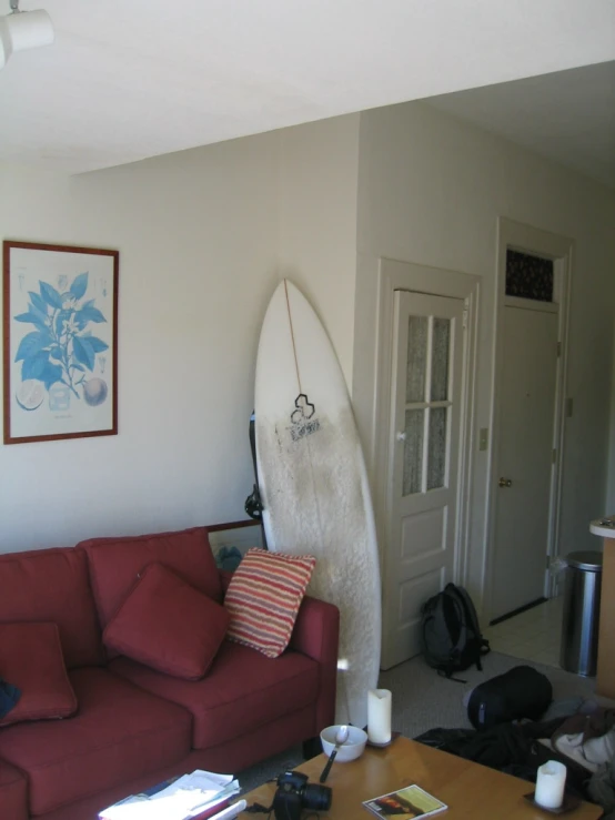a living room with a couch and a surf board